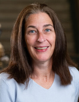 Woman with shoulder length hair wearing a light blue sweater.