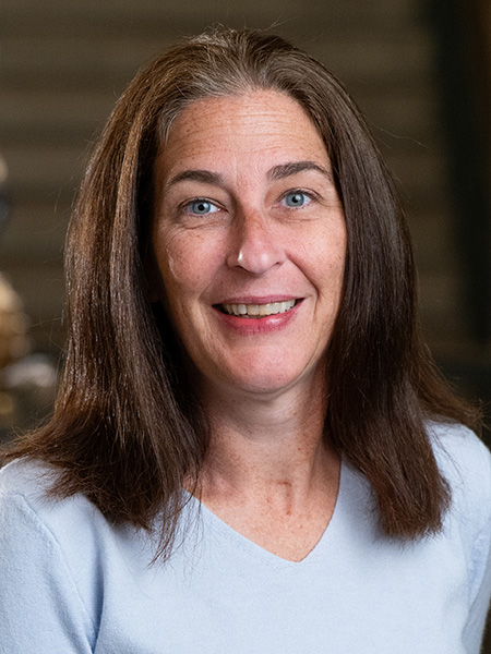 Woman with shoulder length hair wearing a light blue sweater.