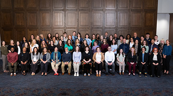 A group of staff standing in multiple rows.